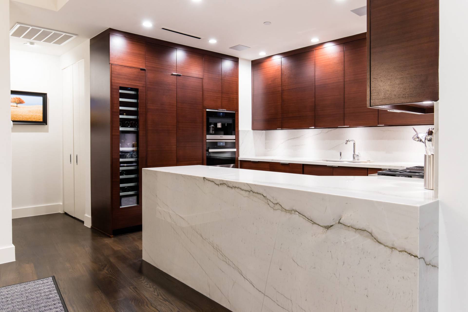 Luxurious cherry wood cabinets with integrated appliances in a Dallas home by StyleCraft Cabinets TX